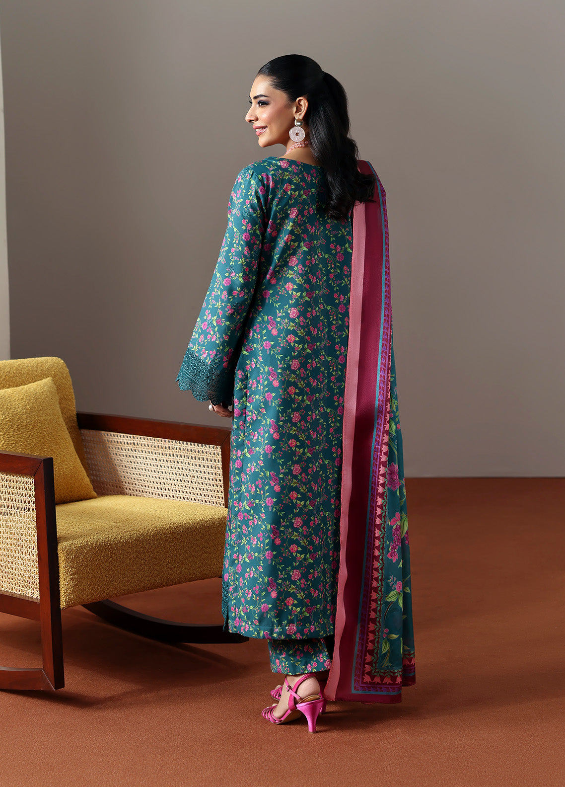 Model wearing Zeirin from Gulaal in a teal green floral printed co-ord set with pink dupatta, ideal for Pakistani luxury pret in the UK.