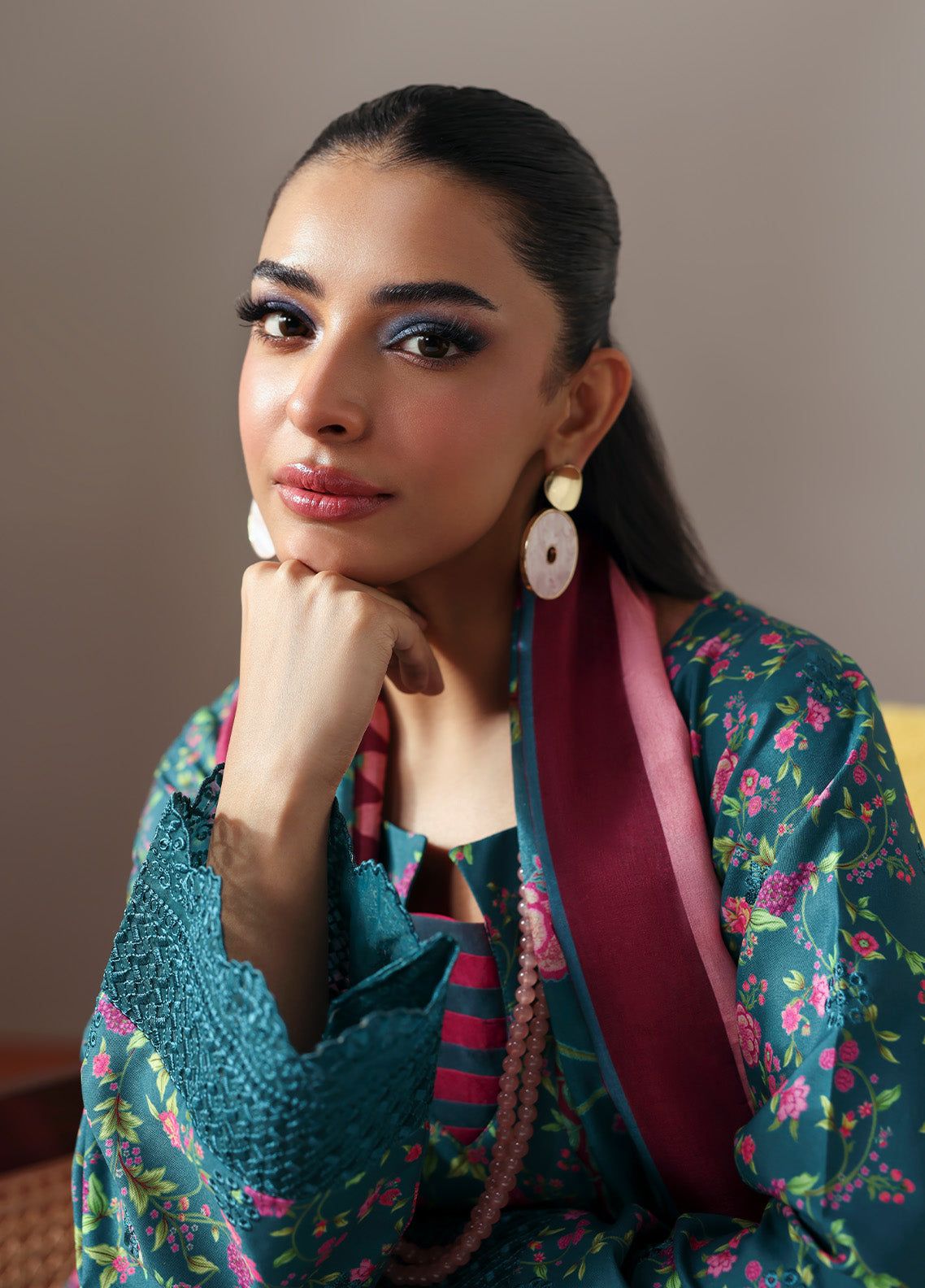 Model wearing Zeirin from Gulaal in a teal green floral printed co-ord set with pink dupatta, ideal for Pakistani luxury pret in the UK.