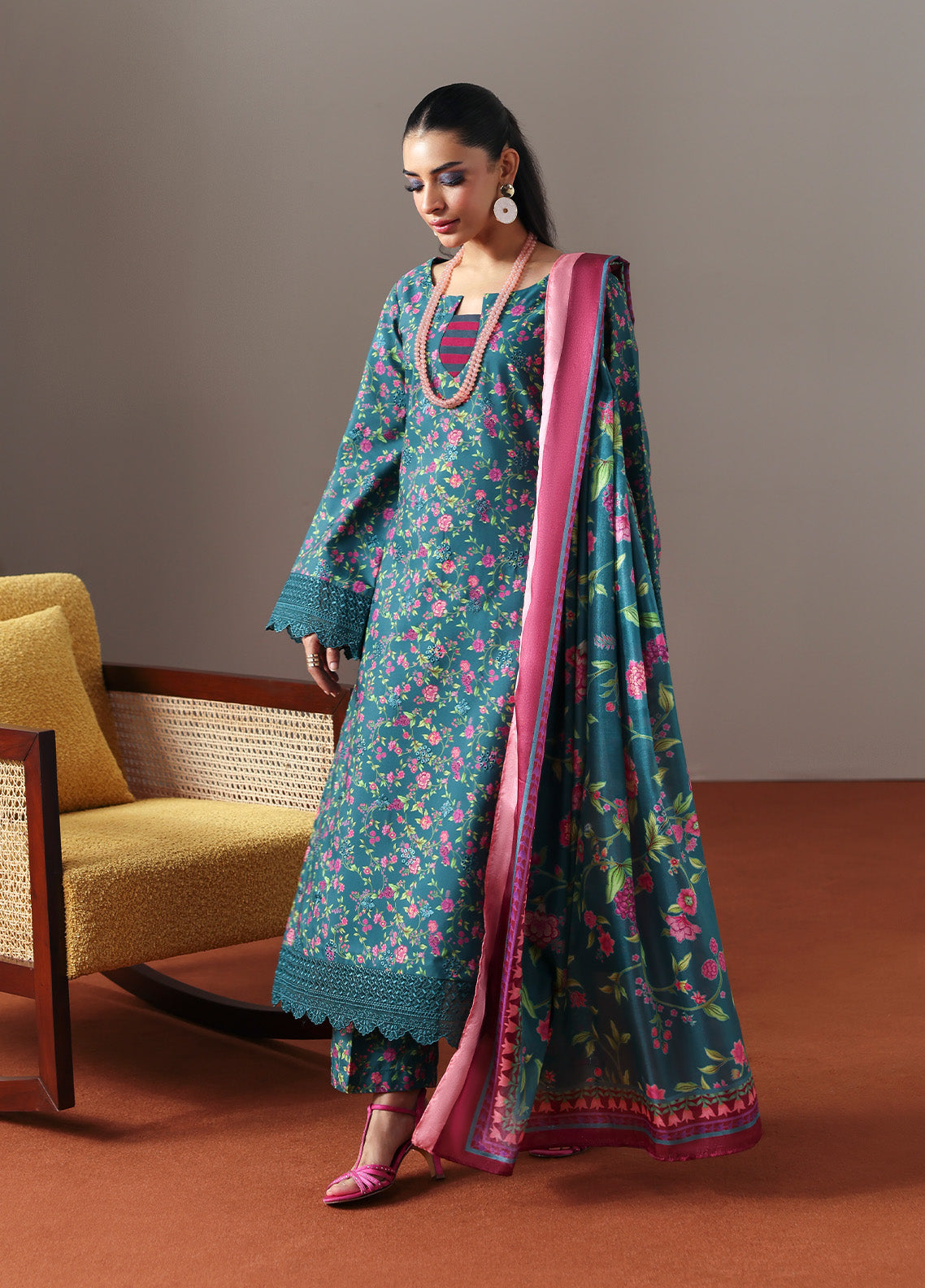Model wearing Zeirin from Gulaal in a teal green floral printed co-ord set with pink dupatta, ideal for Pakistani luxury pret in the UK.