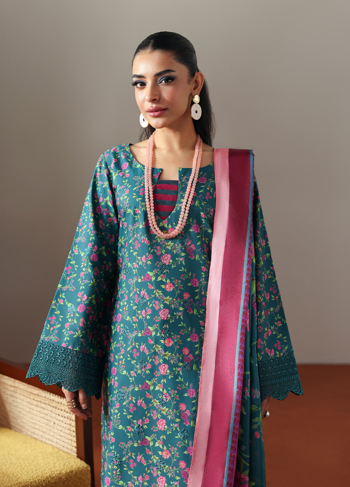 Model wearing Zeirin from Gulaal in a teal green floral printed co-ord set with pink dupatta, ideal for Pakistani luxury pret in the UK.