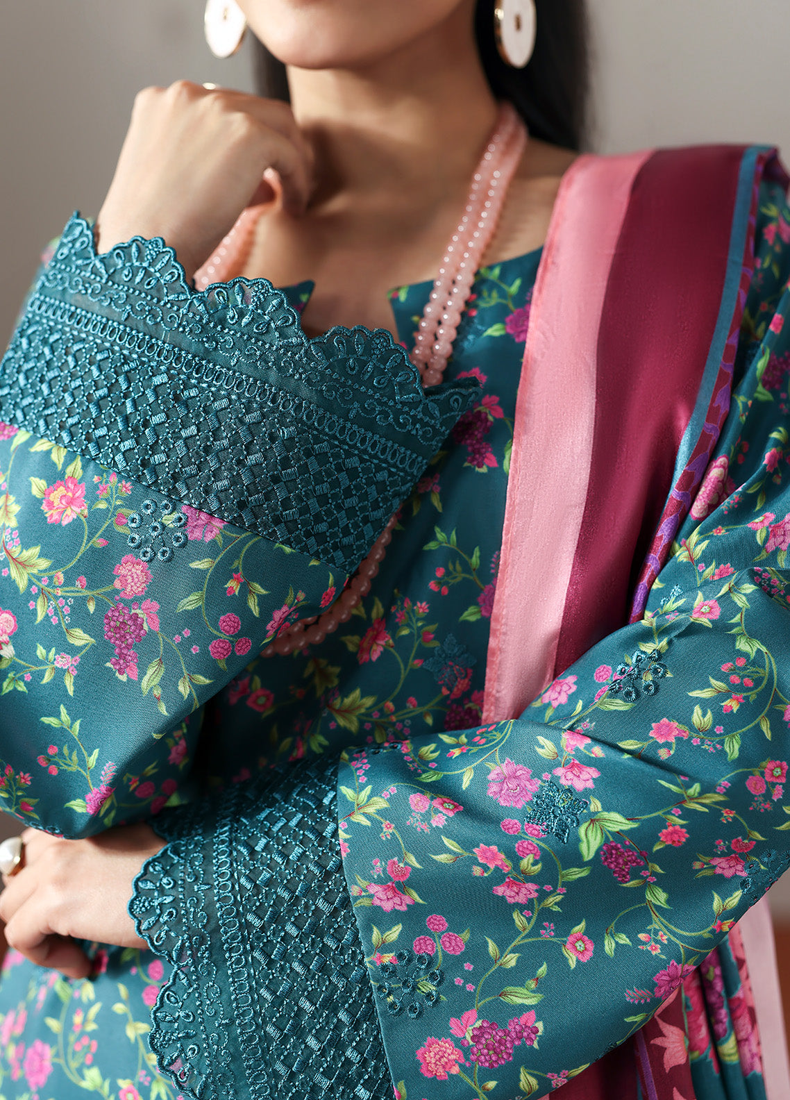 Model wearing Zeirin from Gulaal in a teal green floral printed co-ord set with pink dupatta, ideal for Pakistani luxury pret in the UK.