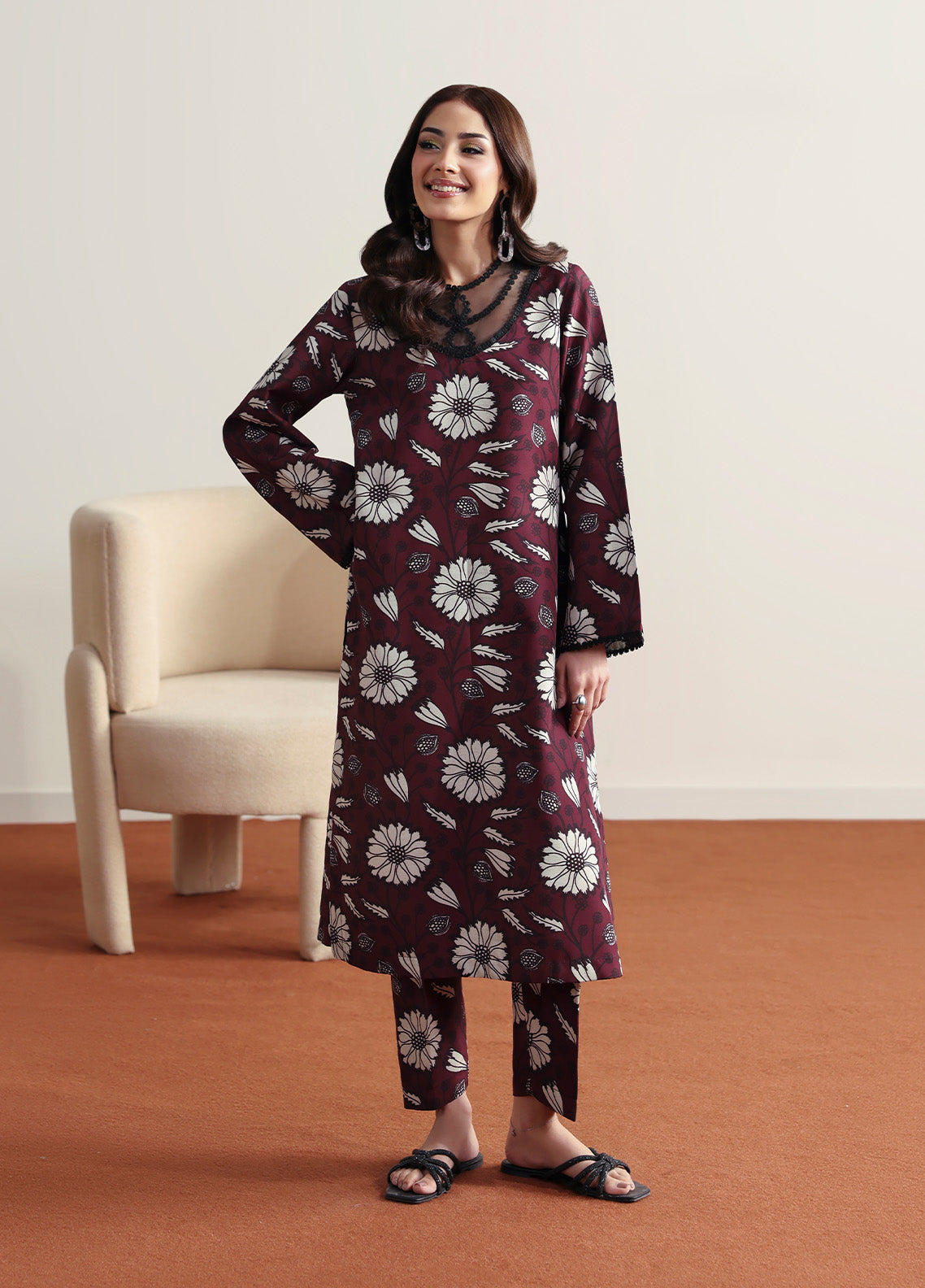 Model wearing Evra from Gulaal in a deep maroon printed co-ord set with bold white floral patterns, perfect for Pakistani luxury pret in the UK.