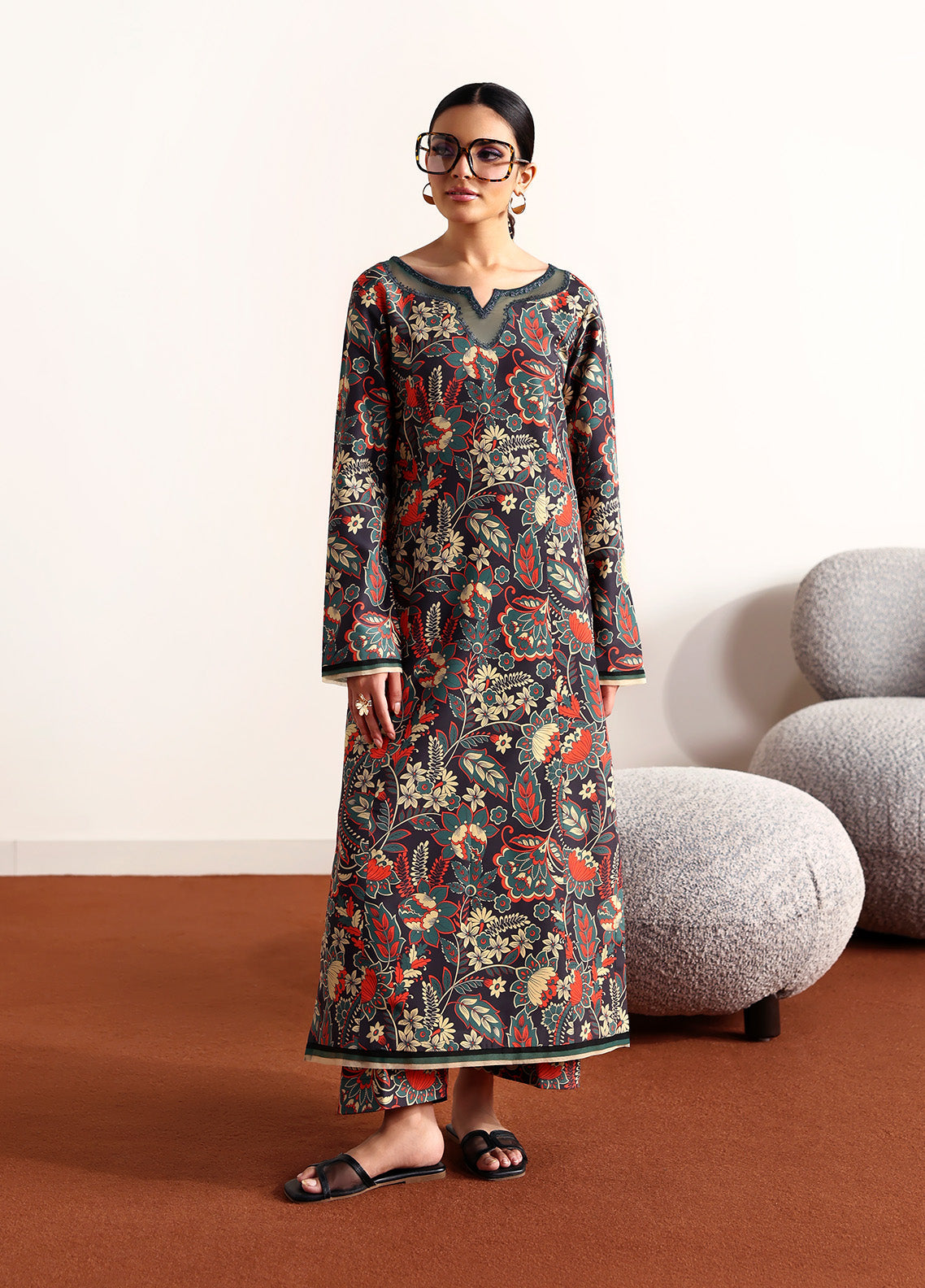 Model wearing Terrie from Gulaal in a dark green printed co-ord set with red and beige floral motifs, ideal for Pakistani luxury pret in the UK.
