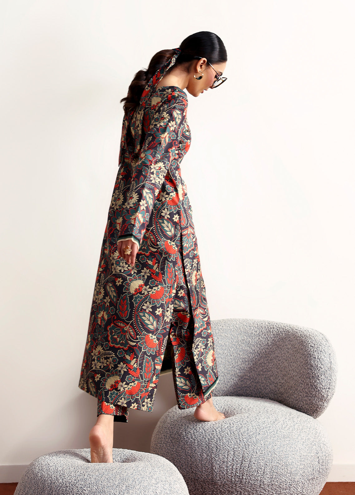 Model wearing Terrie from Gulaal in a dark green printed co-ord set with red and beige floral motifs, ideal for Pakistani luxury pret in the UK.