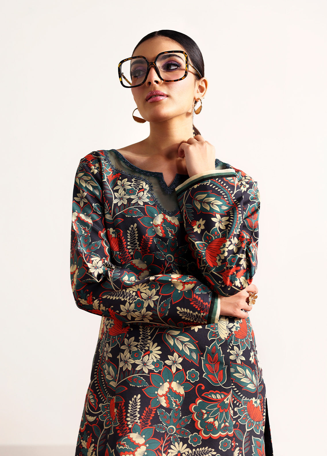 Model wearing Terrie from Gulaal in a dark green printed co-ord set with red and beige floral motifs, ideal for Pakistani luxury pret in the UK.
