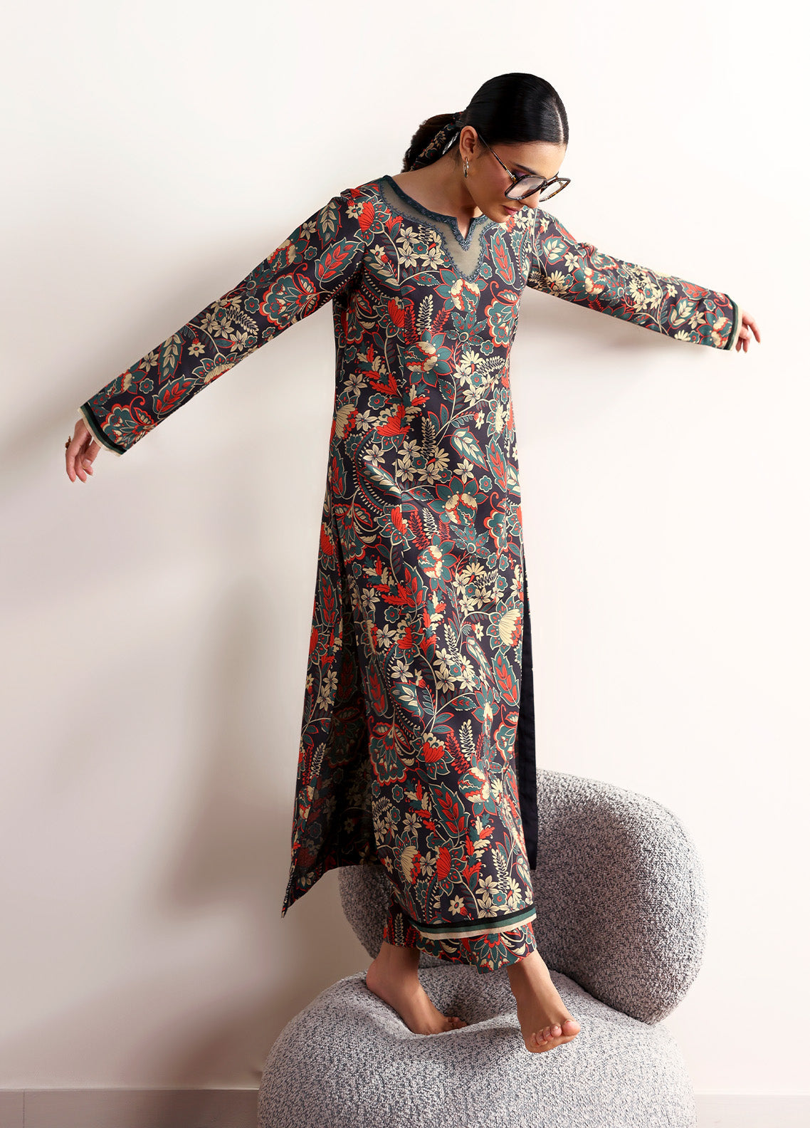 Model wearing Terrie from Gulaal in a dark green printed co-ord set with red and beige floral motifs, ideal for Pakistani luxury pret in the UK.