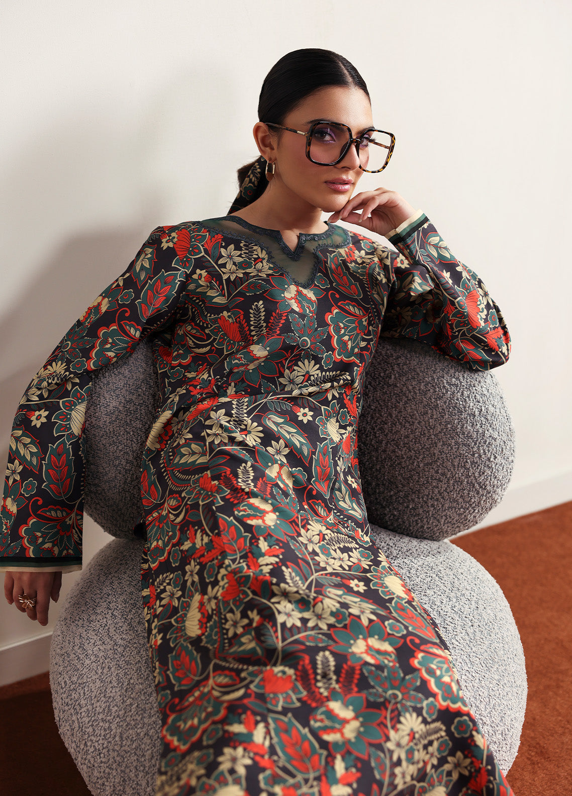 Model wearing Terrie from Gulaal in a dark green printed co-ord set with red and beige floral motifs, ideal for Pakistani luxury pret in the UK.