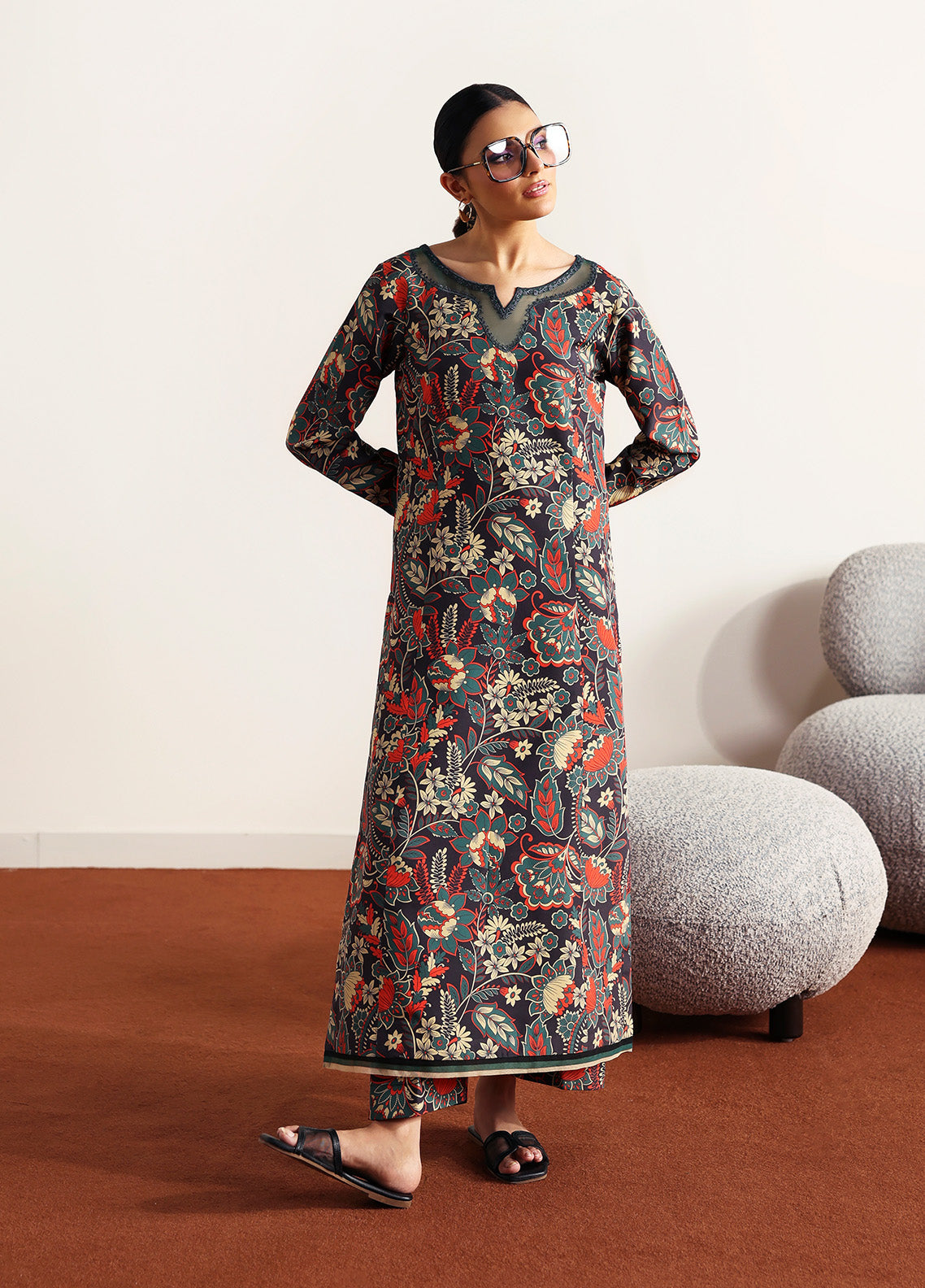 Model wearing Terrie from Gulaal in a dark green printed co-ord set with red and beige floral motifs, ideal for Pakistani luxury pret in the UK.