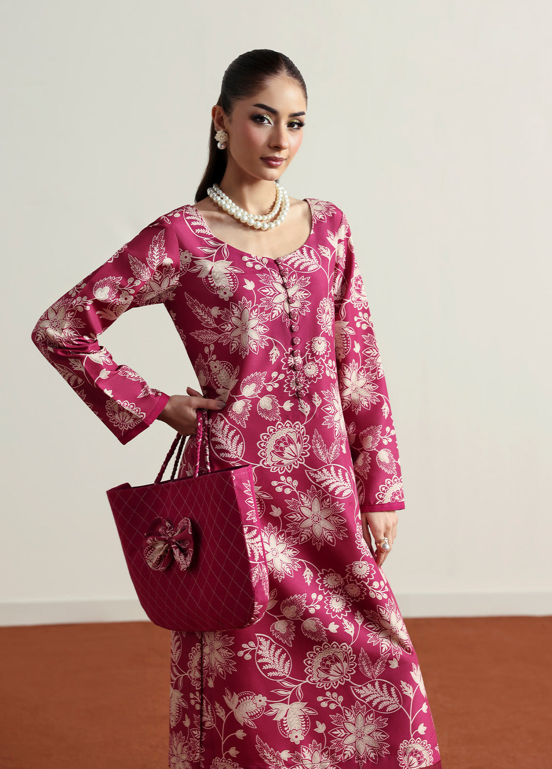 Model wearing Rosalee from Gulaal in a deep pink printed co-ord set with ivory floral patterns, perfect for Pakistani luxury pret in the UK.