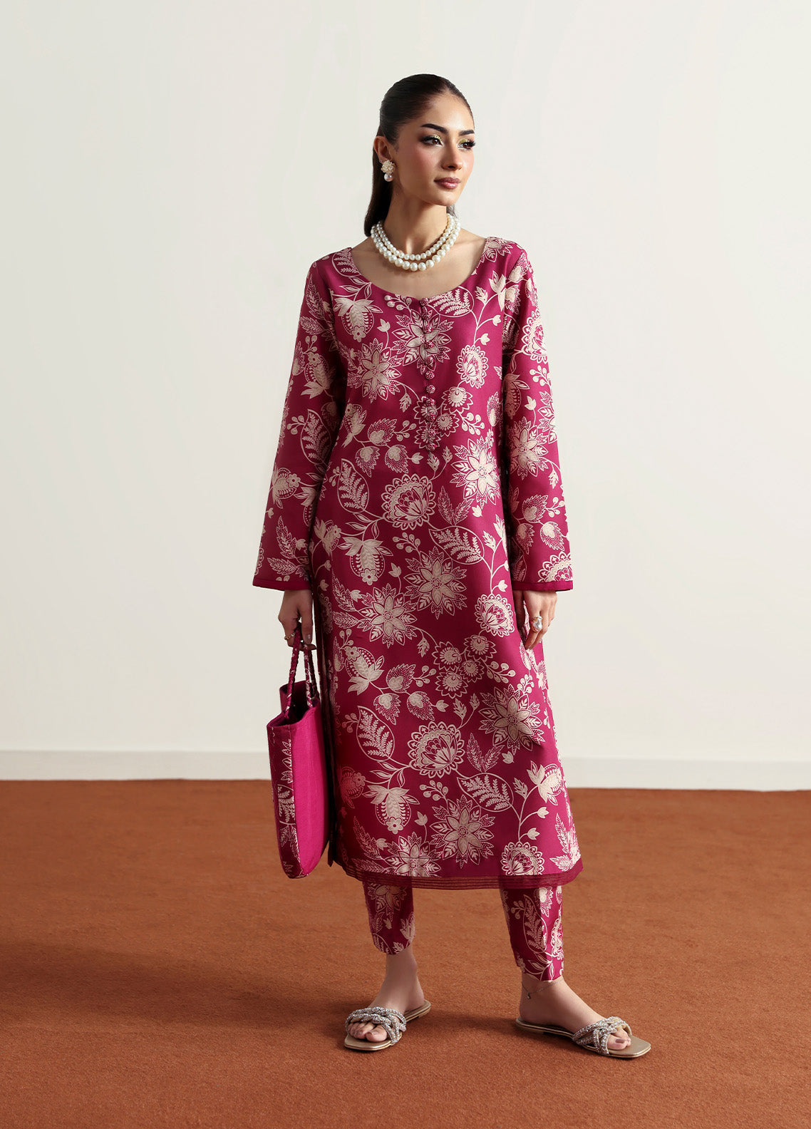 Model wearing Rosalee from Gulaal in a deep pink printed co-ord set with ivory floral patterns, perfect for Pakistani luxury pret in the UK.