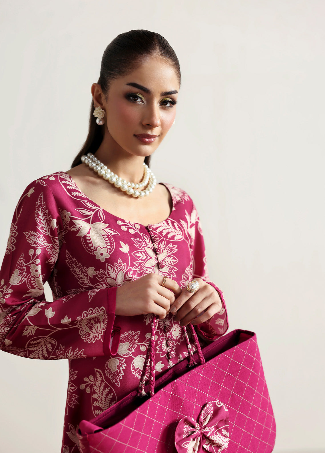 Model wearing Rosalee from Gulaal in a deep pink printed co-ord set with ivory floral patterns, perfect for Pakistani luxury pret in the UK.