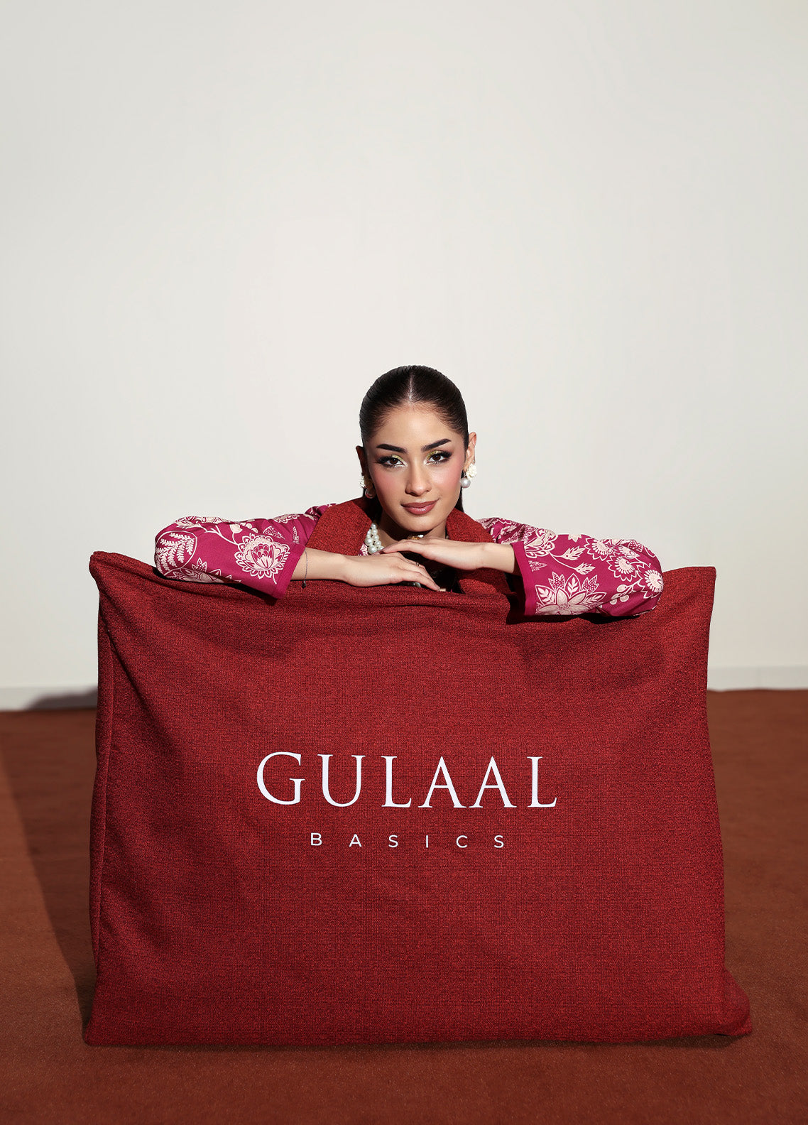 Model wearing Rosalee from Gulaal in a deep pink printed co-ord set with ivory floral patterns, perfect for Pakistani luxury pret in the UK.