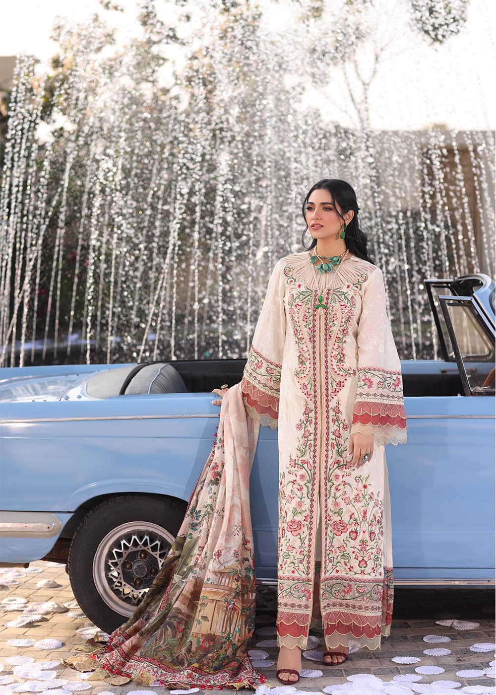 Model wearing off-white and multicolour floral embroidered dress with printed dupatta from Musferah Saad Pretty Girls Luxury Lawn 2025 Bloome. Pakistani clothes online UK.