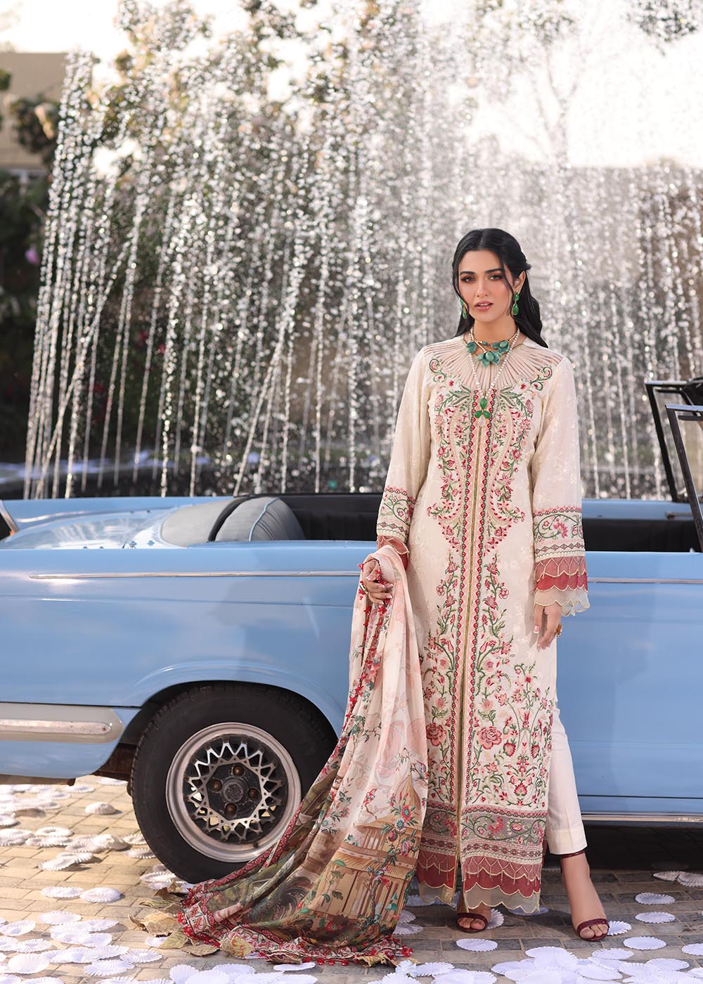 Model wearing off-white and multicolour floral embroidered dress with printed dupatta from Musferah Saad Pretty Girls Luxury Lawn 2025 Bloome. Pakistani clothes online UK.