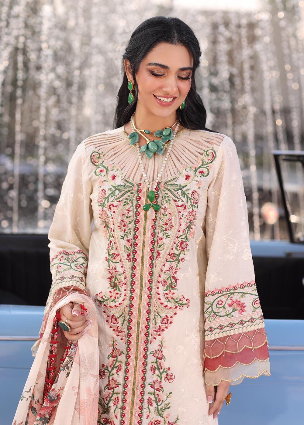 Model wearing off-white and multicolour floral embroidered dress with printed dupatta from Musferah Saad Pretty Girls Luxury Lawn 2025 Bloome. Pakistani clothes online UK.