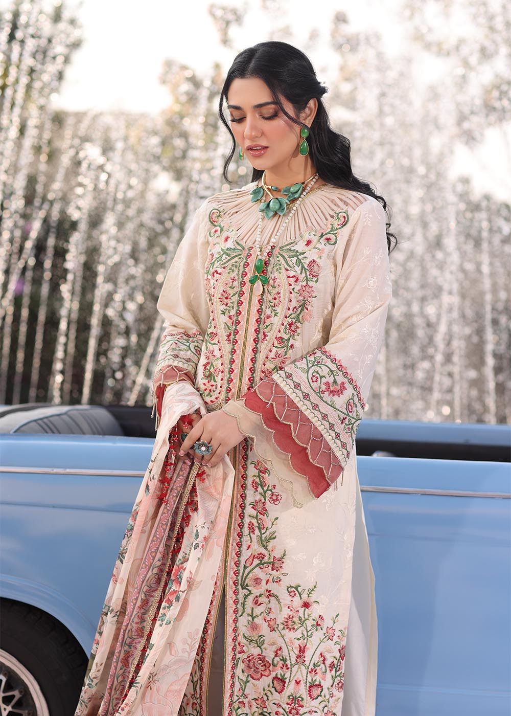 Model wearing off-white and multicolour floral embroidered dress with printed dupatta from Musferah Saad Pretty Girls Luxury Lawn 2025 Bloome. Pakistani clothes online UK.