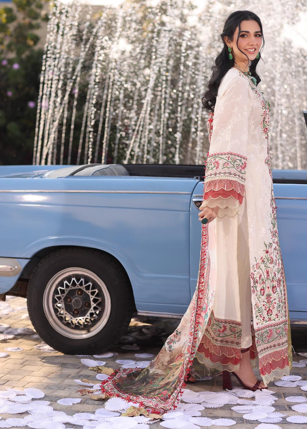 Model wearing off-white and multicolour floral embroidered dress with printed dupatta from Musferah Saad Pretty Girls Luxury Lawn 2025 Bloome. Pakistani clothes online UK.