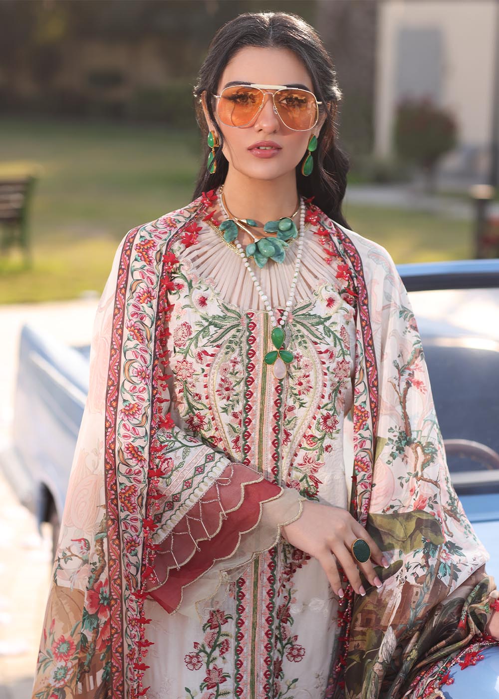 Model wearing off-white and multicolour floral embroidered dress with printed dupatta from Musferah Saad Pretty Girls Luxury Lawn 2025 Bloome. Pakistani clothes online UK.