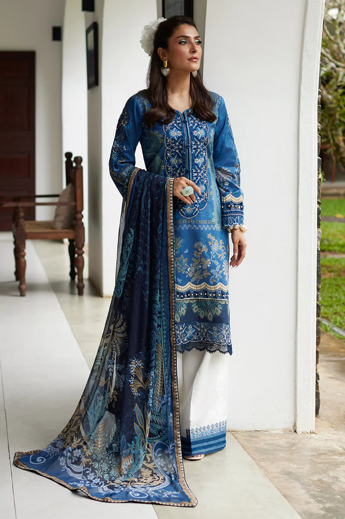 Model wearing Gulaal Saffira Lawn '25 Aadhya in deep blue with intricate embroidery and a printed dupatta. Shop Pakistani luxury pret online in the UK.
