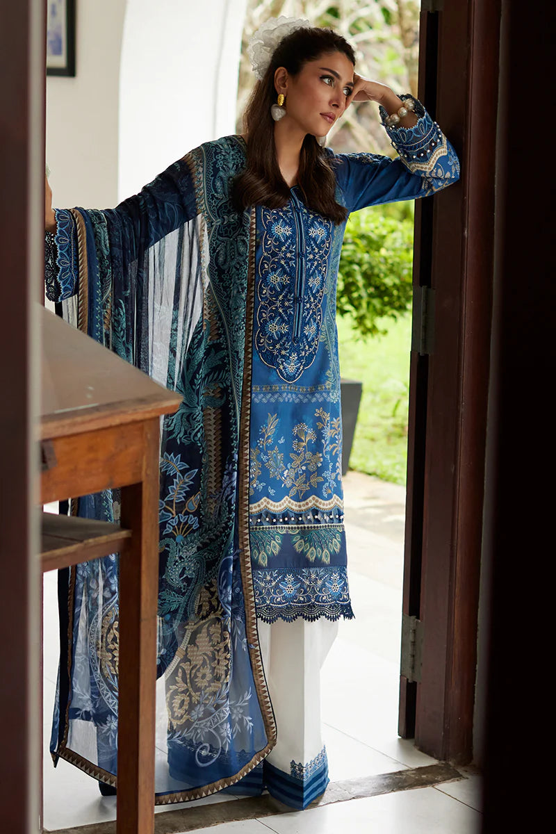 Model wearing Gulaal Saffira Lawn '25 Aadhya in deep blue with intricate embroidery and a printed dupatta. Shop Pakistani luxury pret online in the UK.