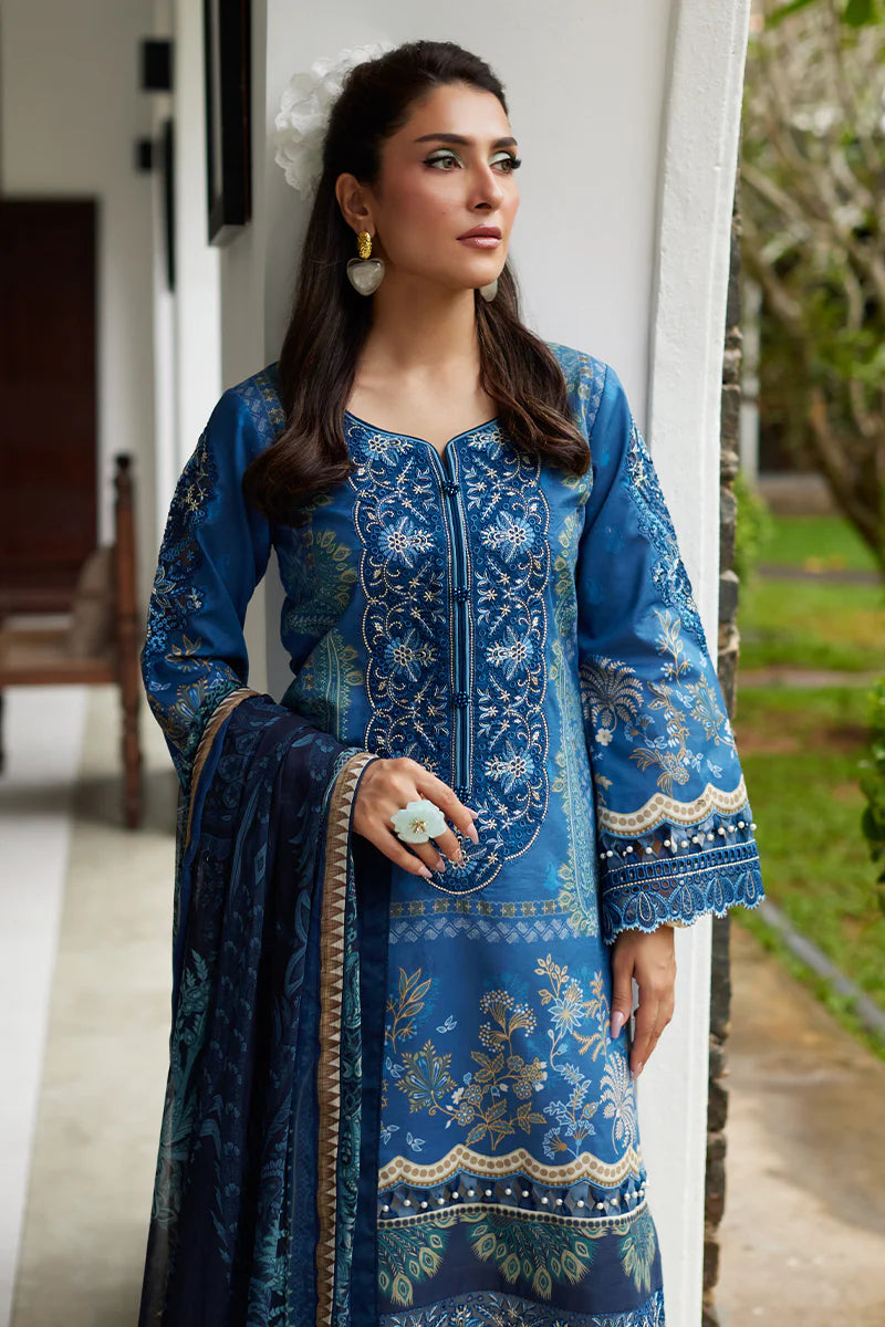Model wearing Gulaal Saffira Lawn '25 Aadhya in deep blue with intricate embroidery and a printed dupatta. Shop Pakistani luxury pret online in the UK.