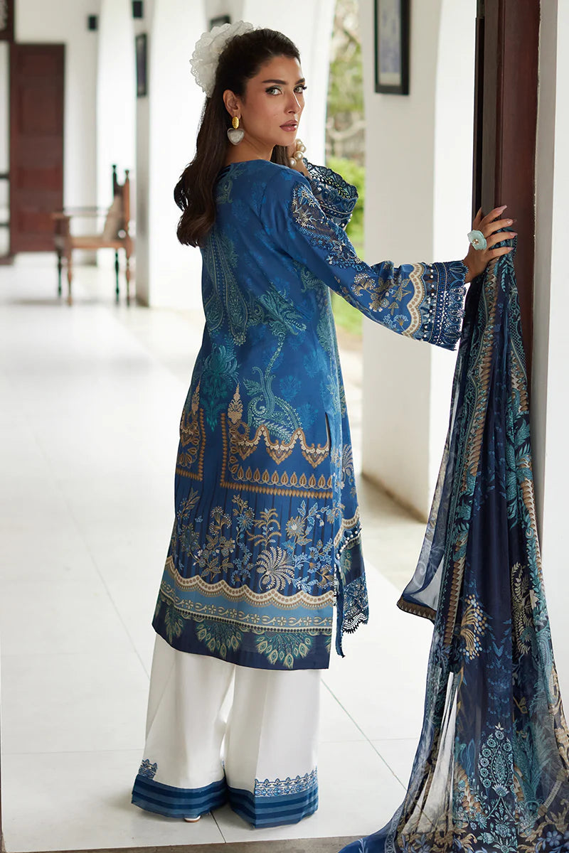 Model wearing Gulaal Saffira Lawn '25 Aadhya in deep blue with intricate embroidery and a printed dupatta. Shop Pakistani luxury pret online in the UK.