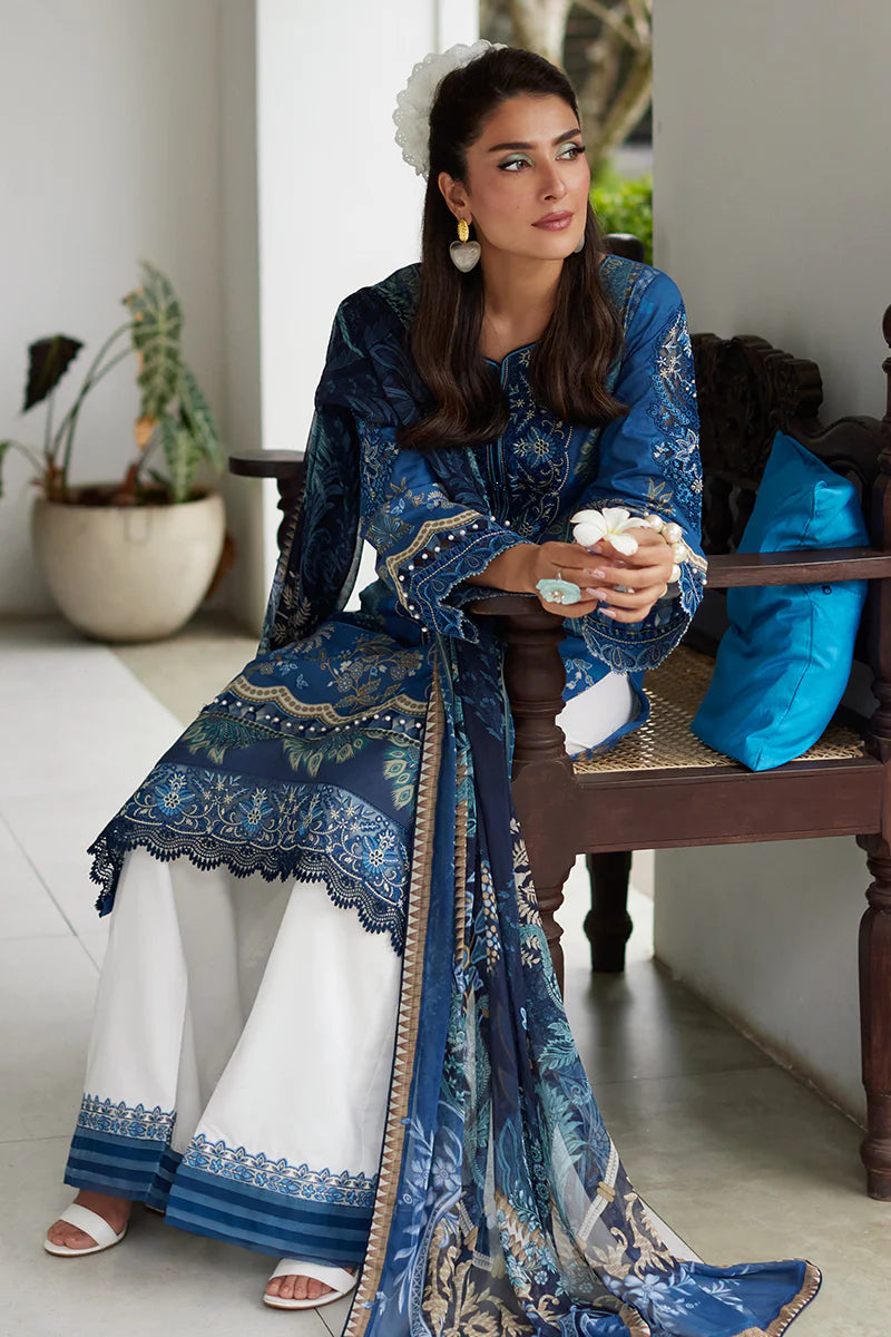Model wearing Gulaal Saffira Lawn '25 Aadhya in deep blue with intricate embroidery and a printed dupatta. Shop Pakistani luxury pret online in the UK.