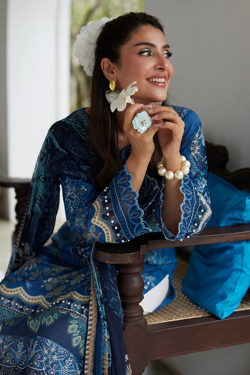 Model wearing Gulaal Saffira Lawn '25 Aadhya in deep blue with intricate embroidery and a printed dupatta. Shop Pakistani luxury pret online in the UK.