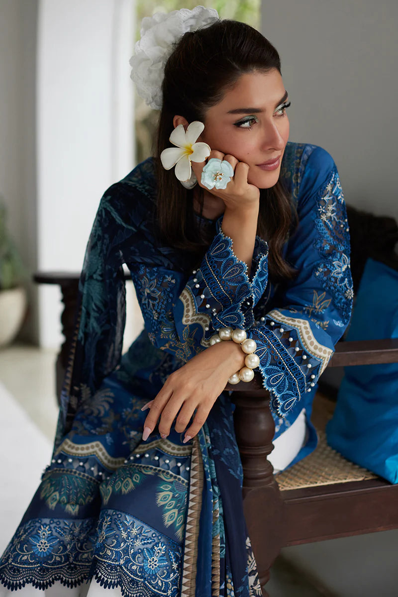 Model wearing Gulaal Saffira Lawn '25 Aadhya in deep blue with intricate embroidery and a printed dupatta. Shop Pakistani luxury pret online in the UK.