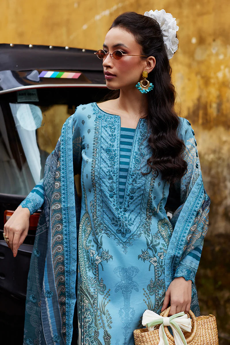 Model wearing Gulaal Saffira Lawn '25 Inayah in ice blue with intricate embroidery and lace details. Shop Pakistani luxury pret online in the UK.