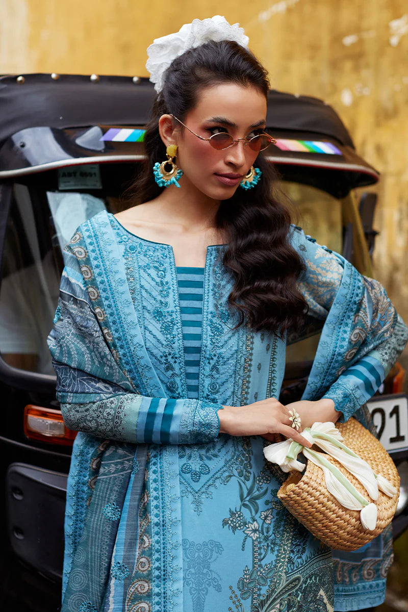 Model wearing Gulaal Saffira Lawn '25 Inayah in ice blue with intricate embroidery and lace details. Shop Pakistani luxury pret online in the UK.