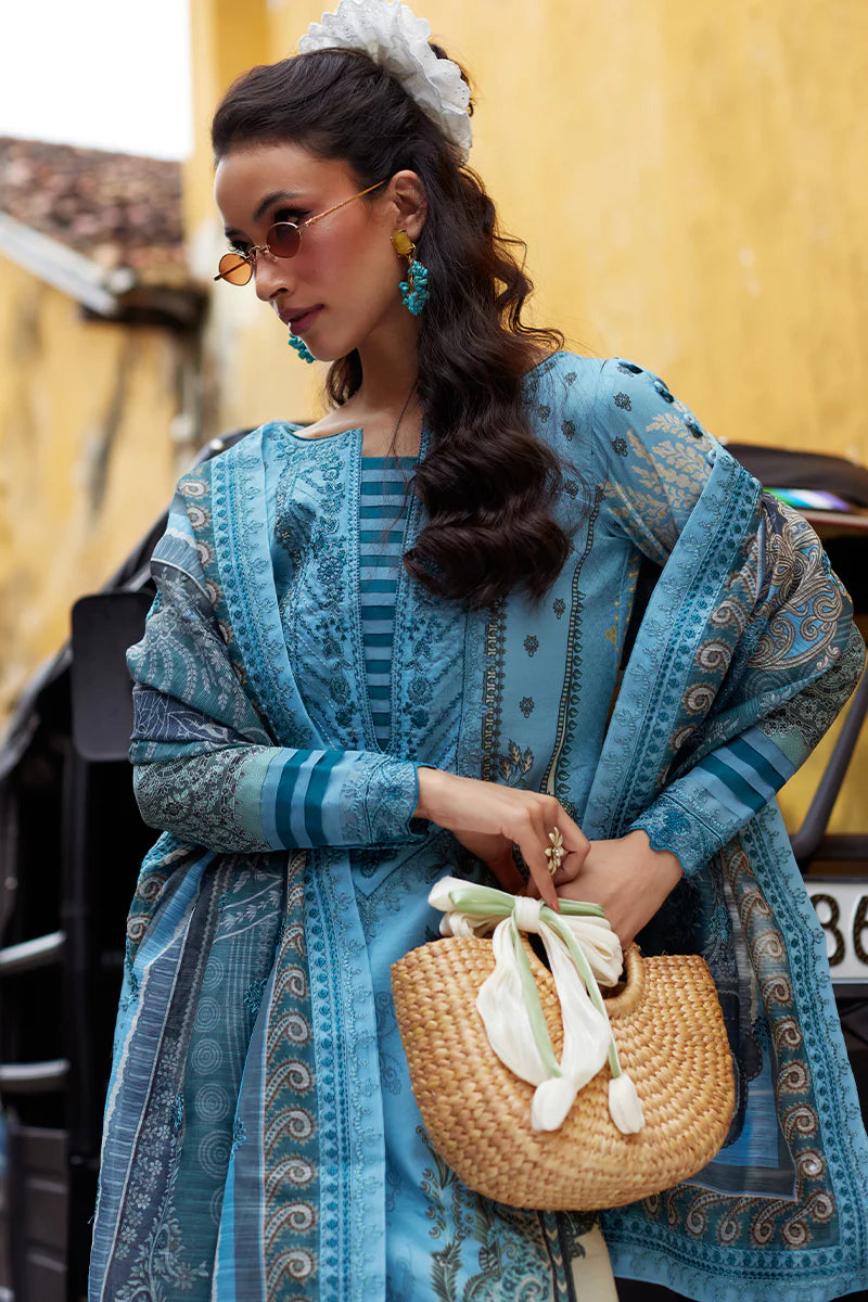 Model wearing Gulaal Saffira Lawn '25 Inayah in ice blue with intricate embroidery and lace details. Shop Pakistani luxury pret online in the UK.