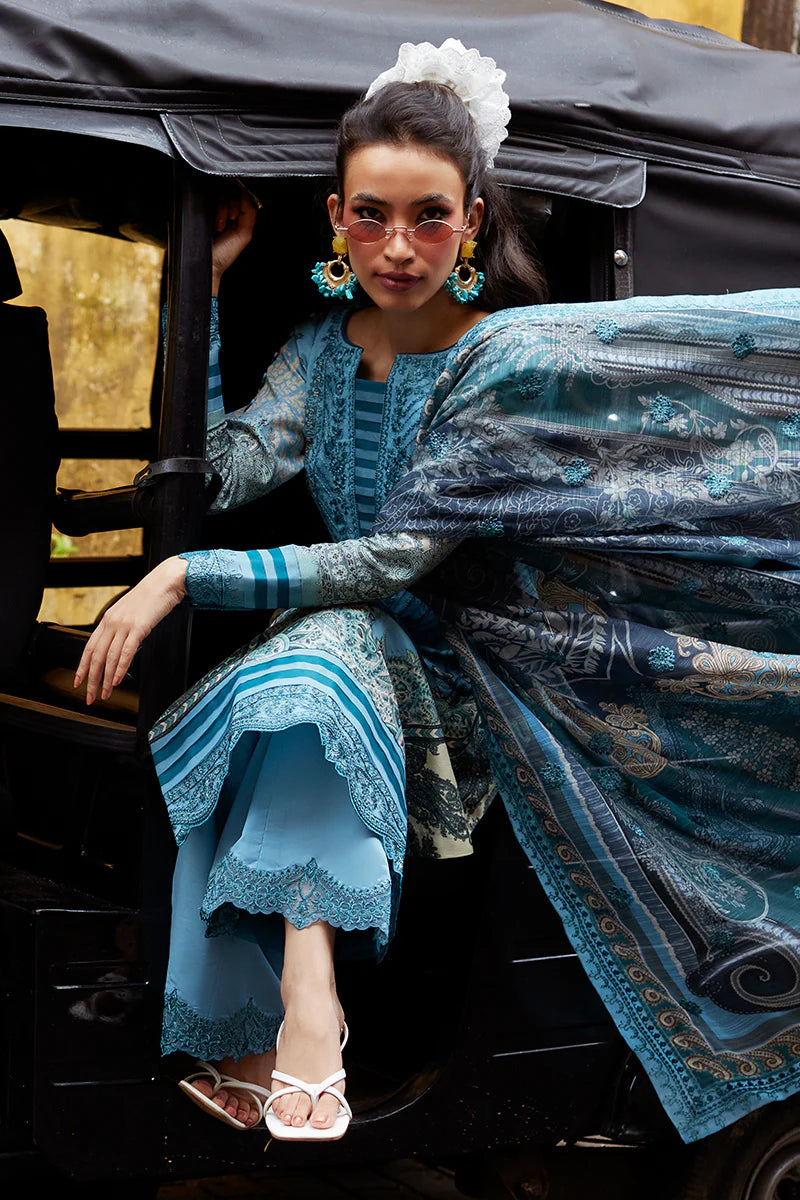 Model wearing Gulaal Saffira Lawn '25 Inayah in ice blue with intricate embroidery and lace details. Shop Pakistani luxury pret online in the UK.