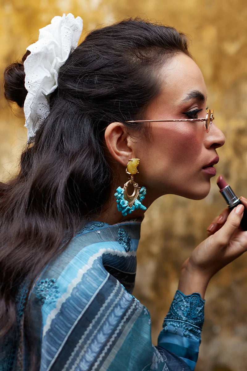 Model wearing Gulaal Saffira Lawn '25 Inayah in ice blue with intricate embroidery and lace details. Shop Pakistani luxury pret online in the UK.