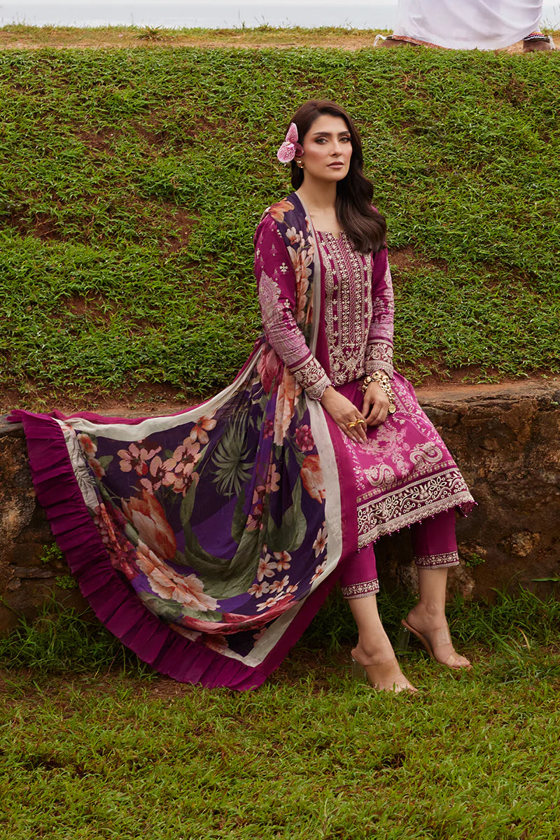 Model wearing Gulaal Saffira Lawn '25 Aria in deep magenta with intricate embroidery and a printed dupatta. Shop Pakistani luxury pret online in the UK.