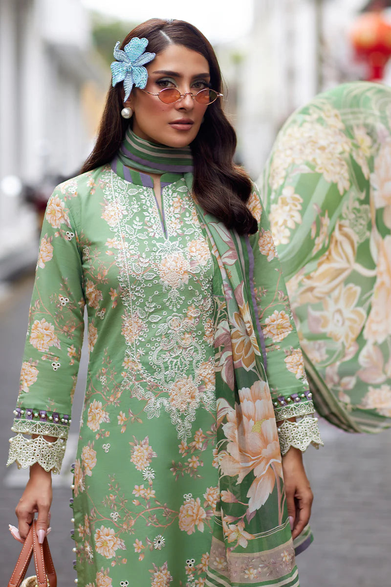 Model wearing Gulaal Saffira Lawn '25 Nora in green with intricate floral embroidery and lace detailing. Shop Pakistani luxury pret online in the UK.