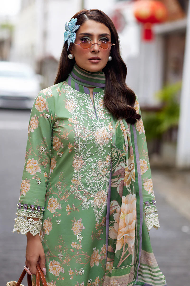 Model wearing Gulaal Saffira Lawn '25 Nora in green with intricate floral embroidery and lace detailing. Shop Pakistani luxury pret online in the UK.
