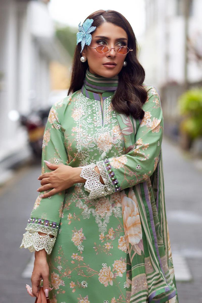 Model wearing Gulaal Saffira Lawn '25 Nora in green with intricate floral embroidery and lace detailing. Shop Pakistani luxury pret online in the UK.