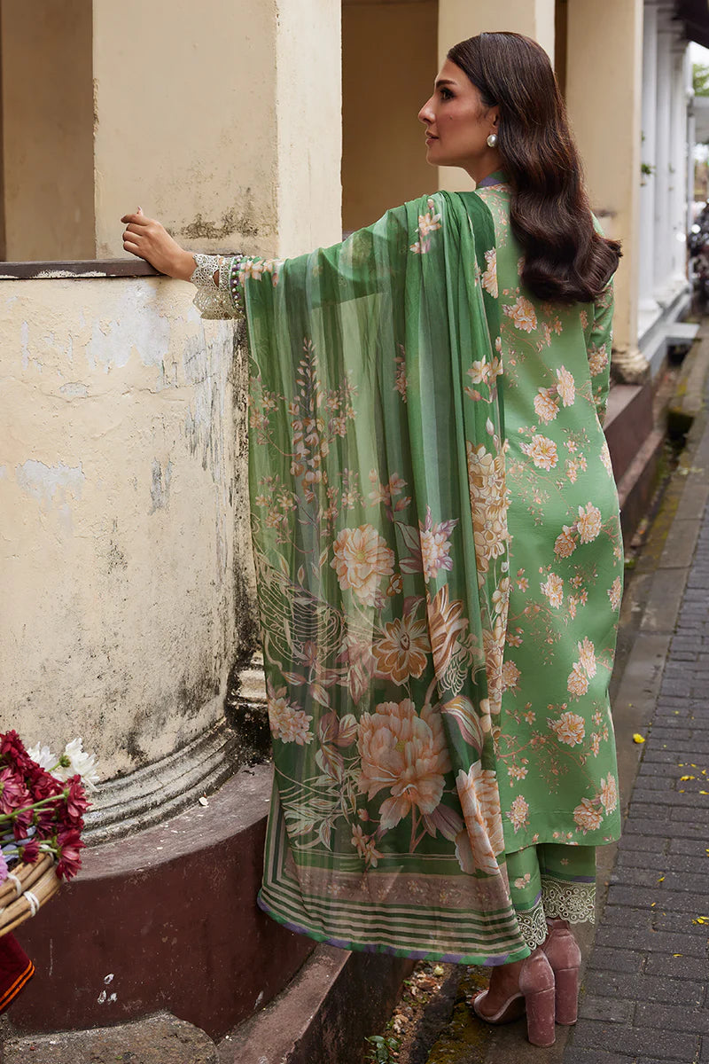 Model wearing Gulaal Saffira Lawn '25 Nora in green with intricate floral embroidery and lace detailing. Shop Pakistani luxury pret online in the UK.