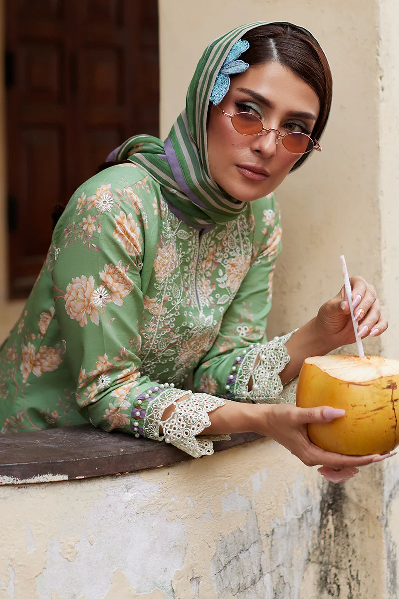 Model wearing Gulaal Saffira Lawn '25 Nora in green with intricate floral embroidery and lace detailing. Shop Pakistani luxury pret online in the UK.