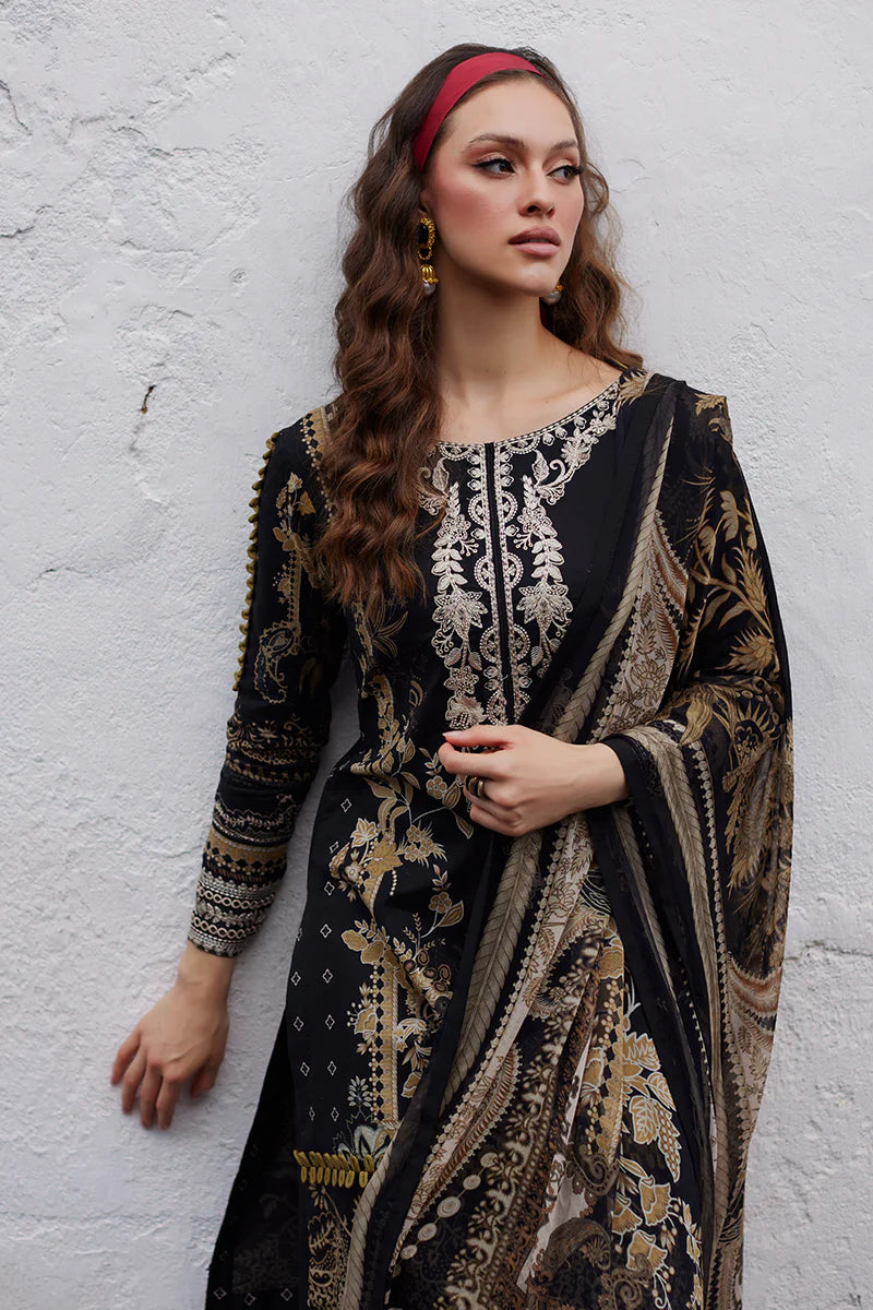 Model wearing Gulaal Saffira Lawn '25 Amiri in black with intricate gold embroidery and matching dupatta. Shop Pakistani luxury pret online in the UK.