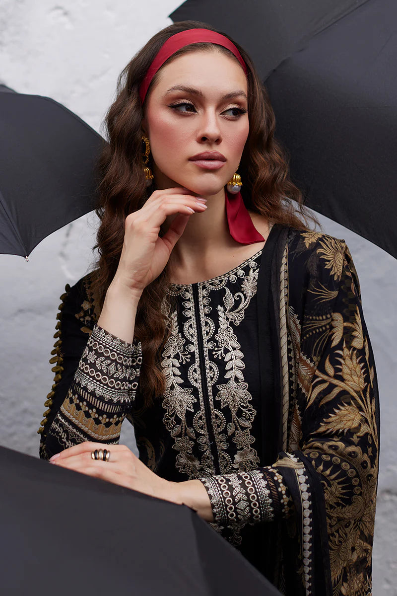Model wearing Gulaal Saffira Lawn '25 Amiri in black with intricate gold embroidery and matching dupatta. Shop Pakistani luxury pret online in the UK.