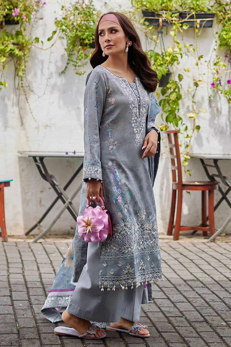 Model wearing Gulaal Saffira Lawn '25 Carla in soft grey with intricate floral embroidery and a gradient dupatta. Shop Pakistani luxury pret online in the UK.