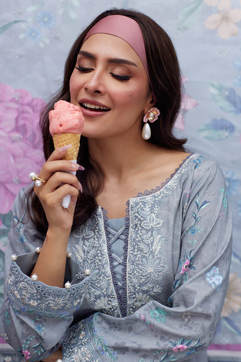Model wearing Gulaal Saffira Lawn '25 Carla in soft grey with intricate floral embroidery and a gradient dupatta. Shop Pakistani luxury pret online in the UK.