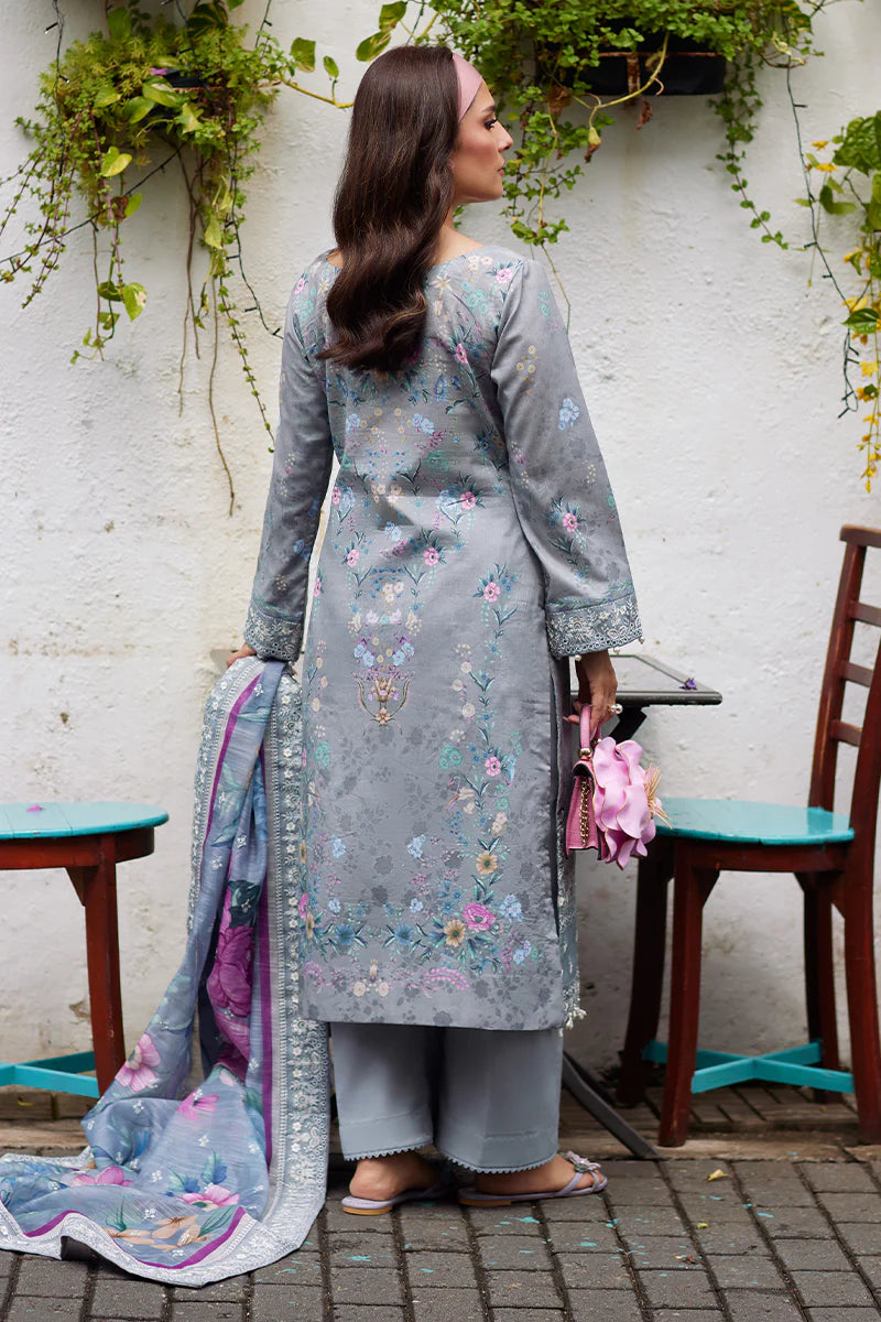 Model wearing Gulaal Saffira Lawn '25 Carla in soft grey with intricate floral embroidery and a gradient dupatta. Shop Pakistani luxury pret online in the UK.