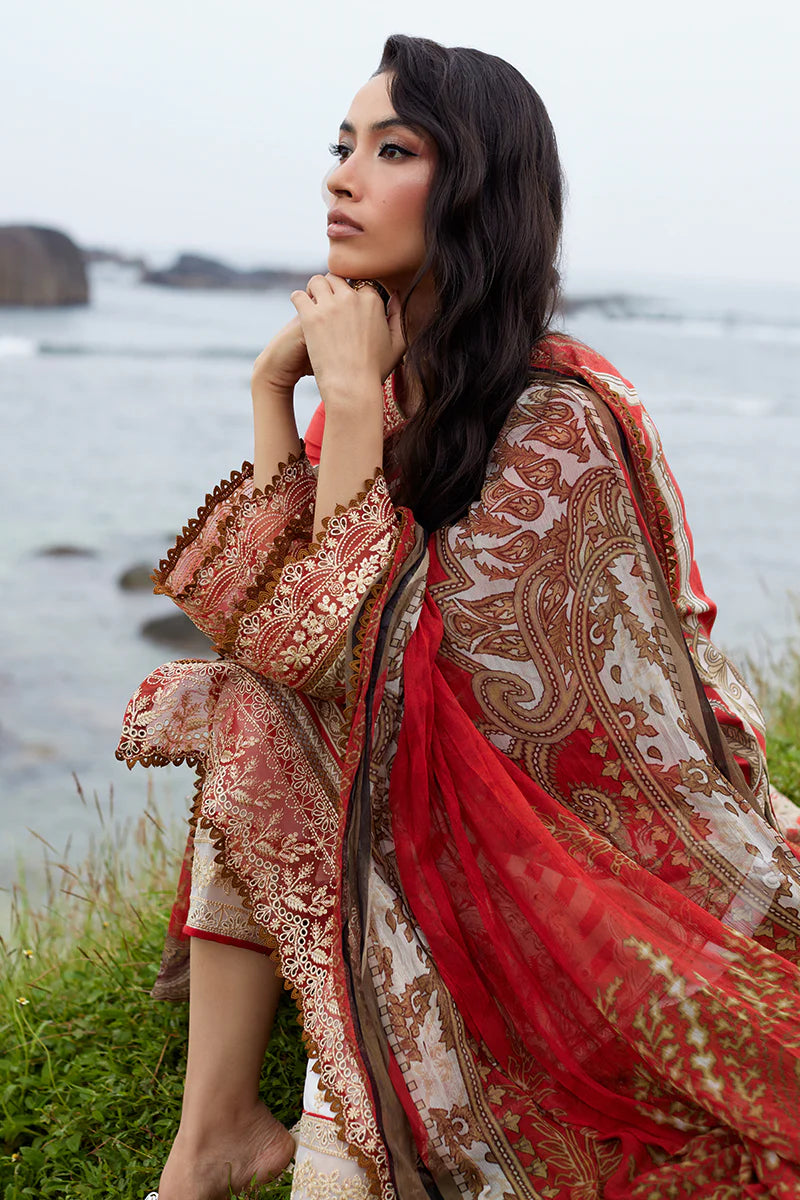 Model wearing Gulaal Saffira Lawn '25 Zhuri in red with intricate gold embroidery and printed dupatta. Shop Pakistani luxury pret online in the UK.