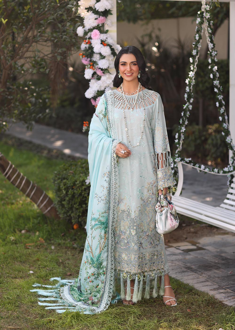 Model wearing pastel blue embroidered dress with tassel detailing from Musferah Saad's Selene, Pakistani luxury pret available online in UK.