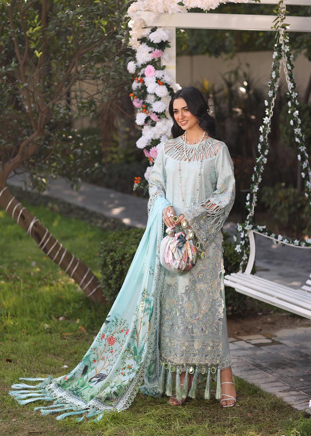 Model wearing pastel blue embroidered dress with tassel detailing from Musferah Saad's Selene, Pakistani luxury pret available online in UK.