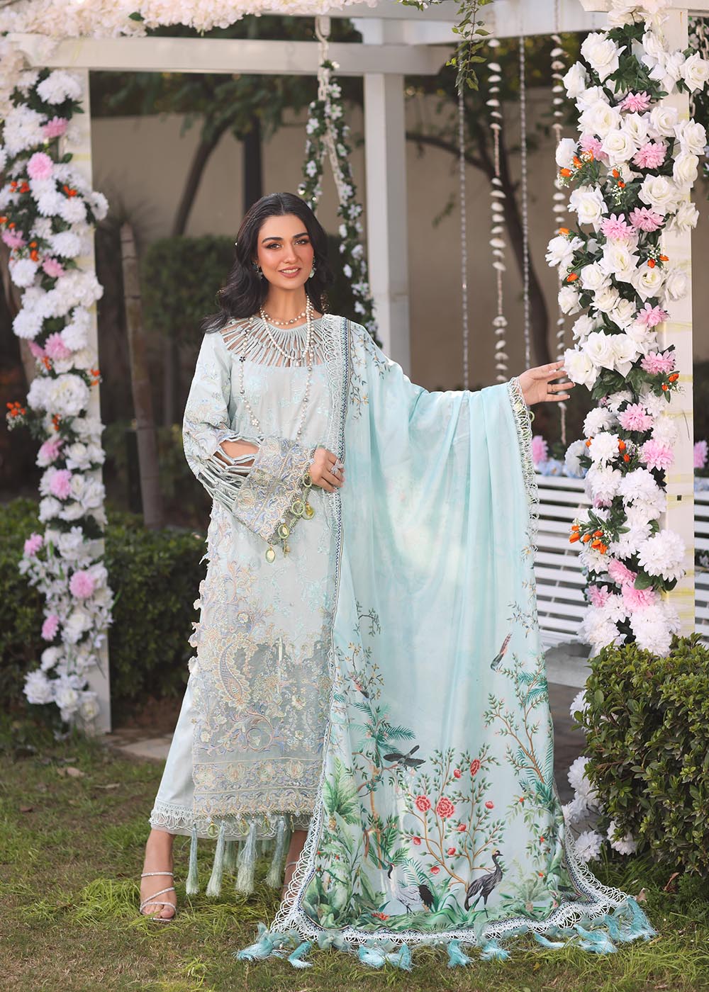 Model wearing pastel blue embroidered dress with tassel detailing from Musferah Saad's Selene, Pakistani luxury pret available online in UK.