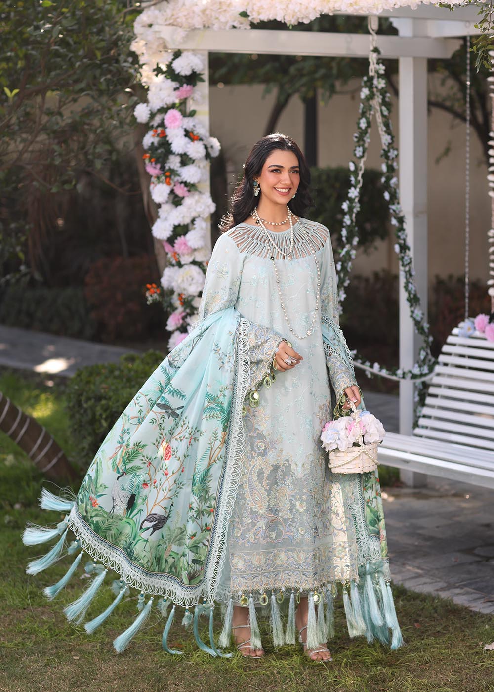 Model wearing pastel blue embroidered dress with tassel detailing from Musferah Saad's Selene, Pakistani luxury pret available online in UK.